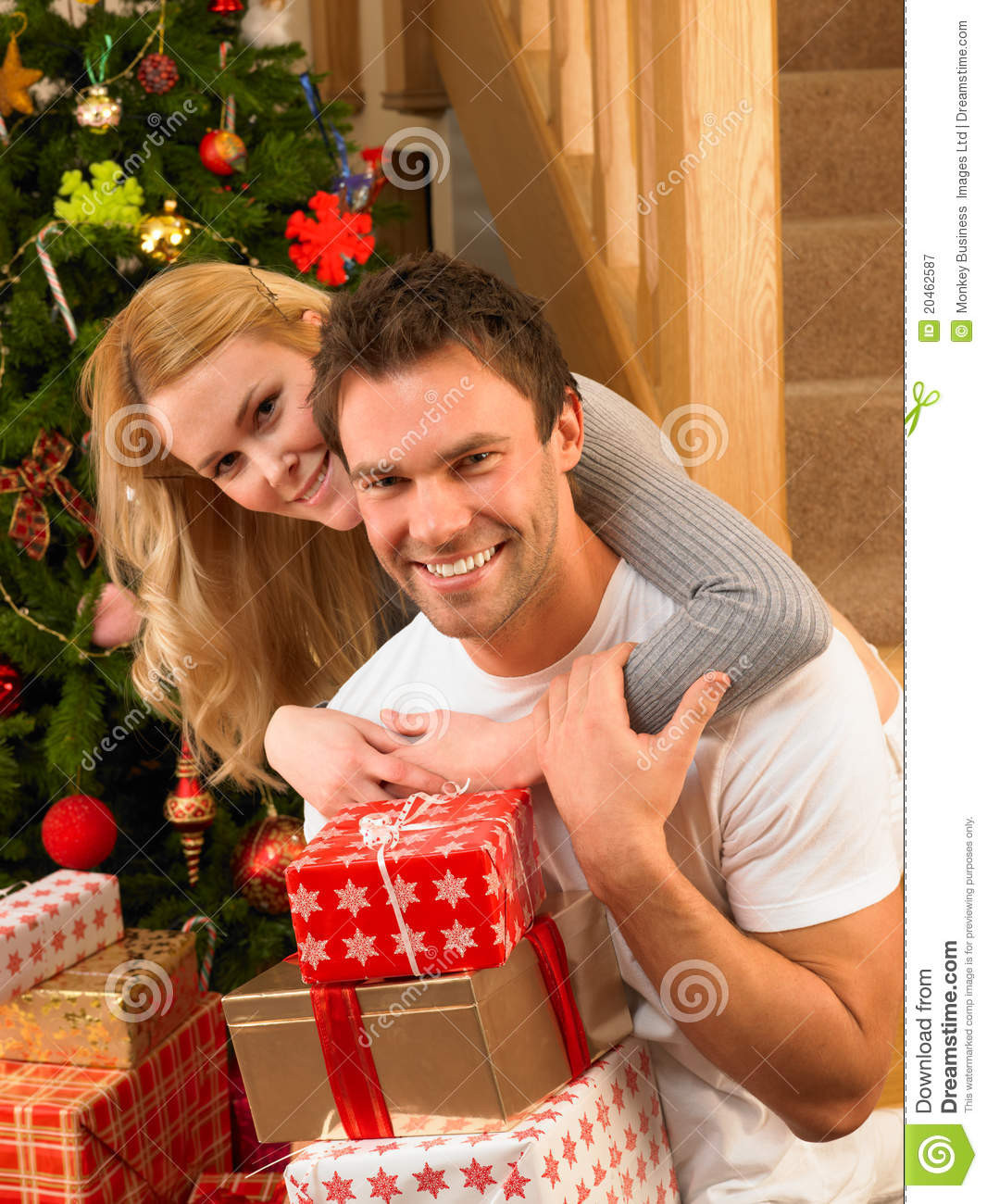 Gift Ideas For Young Couple
 Young Couple At Christmas Exchanging Gifts Royalty Free
