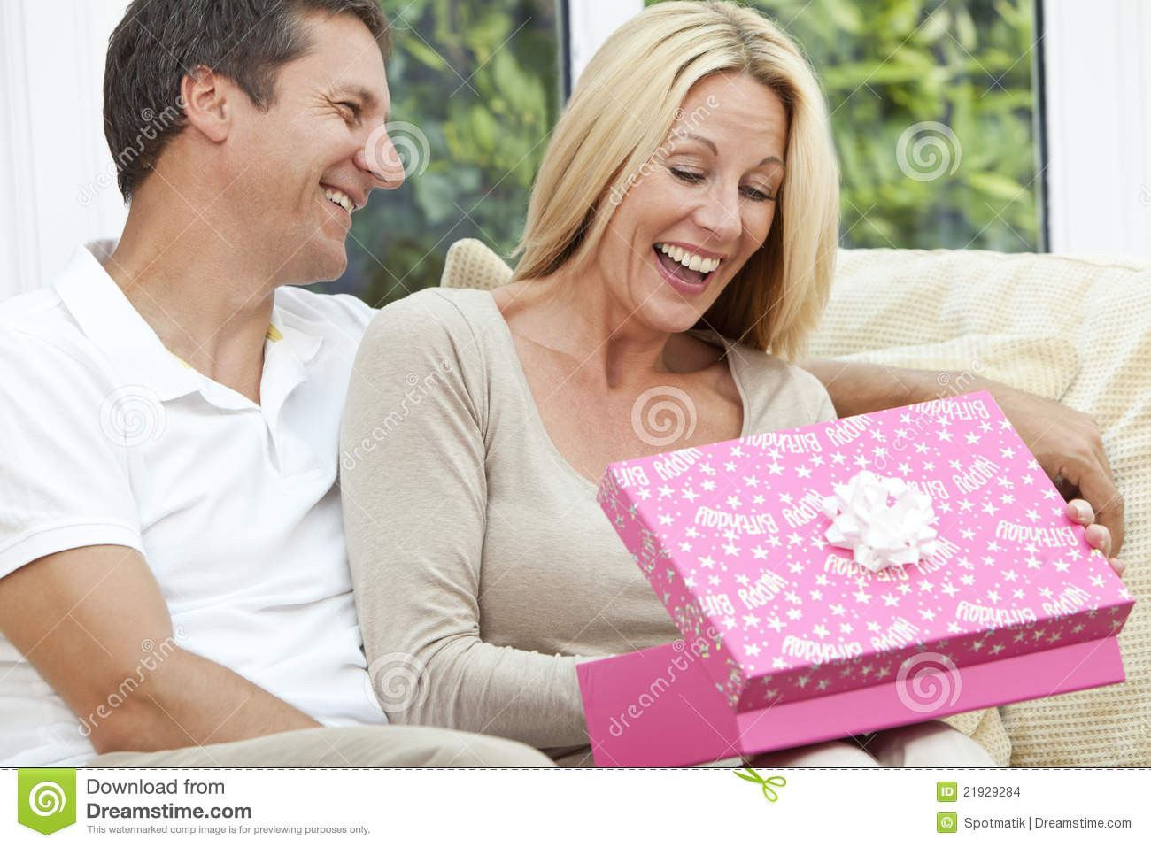 Wedding Gift Ideas For Middle Aged Couple
 Happy Man & Woman Couple Opening Birthday Present Stock
