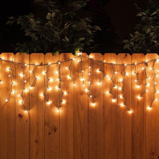 Christmas Lights On Fence Ideas
 White icicle string lights along the fence a perfect