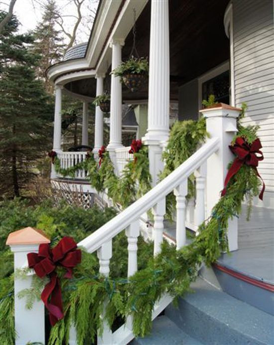 Front Porch Garland Christmas
 Fresh evergreen garland draped on the front porch is a