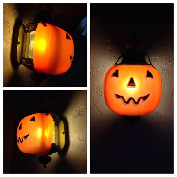 Halloween Porch Light Covers
 Cut a plastic jack o lantern bucket to create a festive